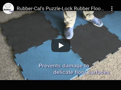 Puzzle lock DIY garage floor Person Standing on blue and black puzzle tile floor