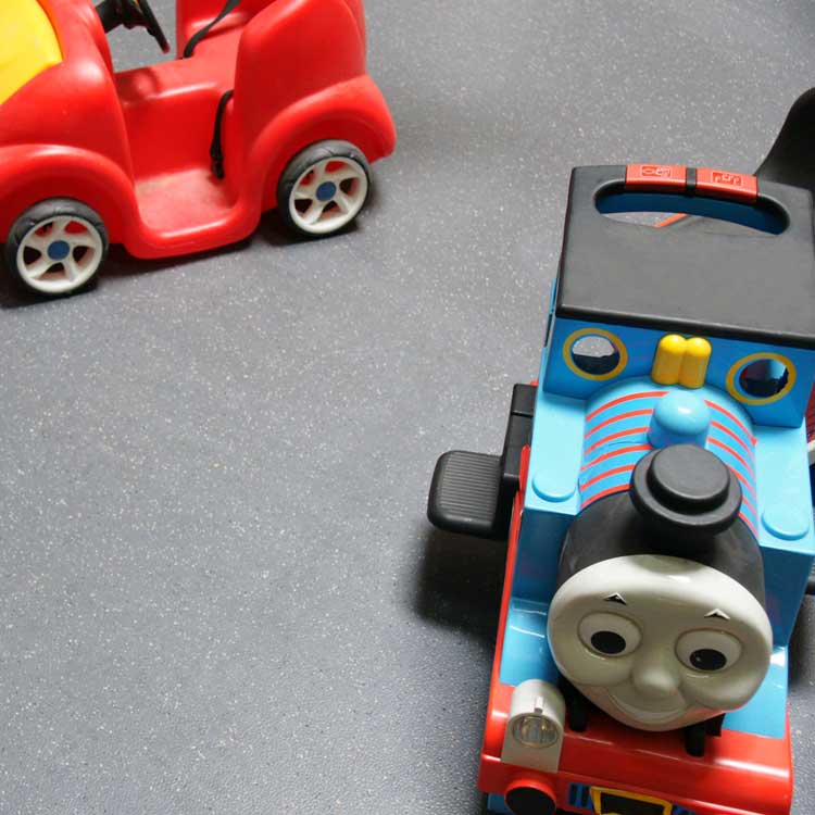 Concrete Colored Terra Flex Rubber Flooring Under Toy Train in a playroom