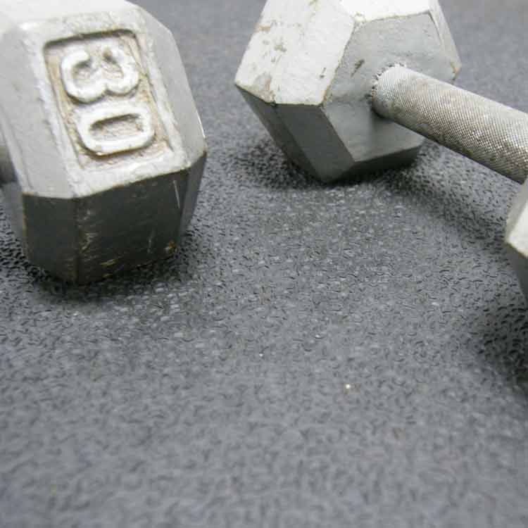 kettlebell on black tuff flex rubber mat in gym floor