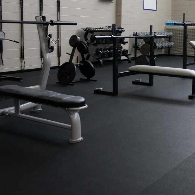 Z cycle flooring used under weight benches at a gym.