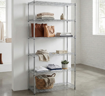 Freestanding chrome wire shelving with white and black boxes inside of it.