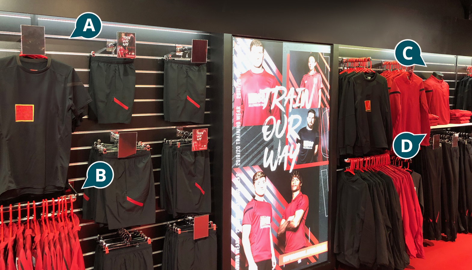 Clothing on display in a football store, with highlighted products