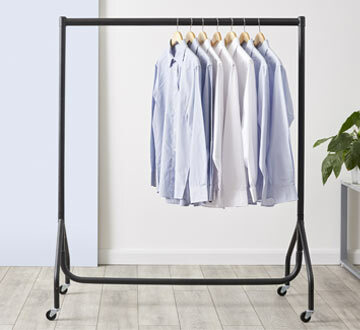 Heavy Duty 4ft Black clothing rails with shirts hanging off it.