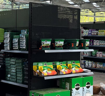 Shelfs in a convience store, lined up with products.