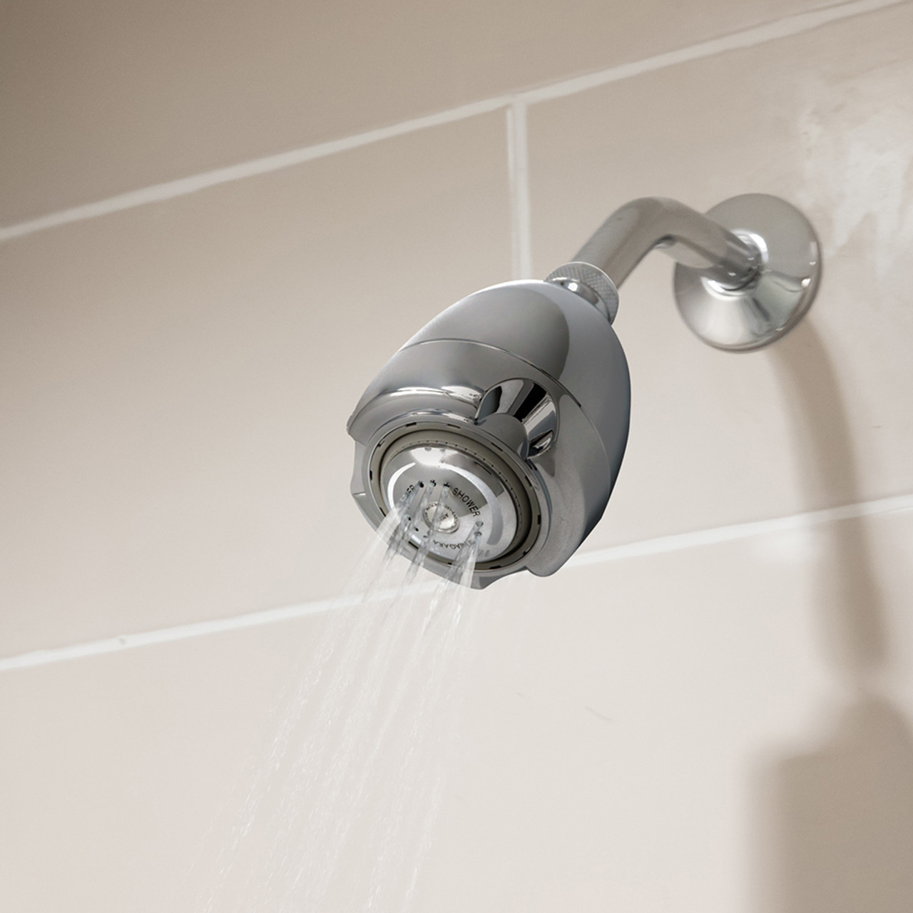 Earth Chrome Showerhead on wall with water spraying
