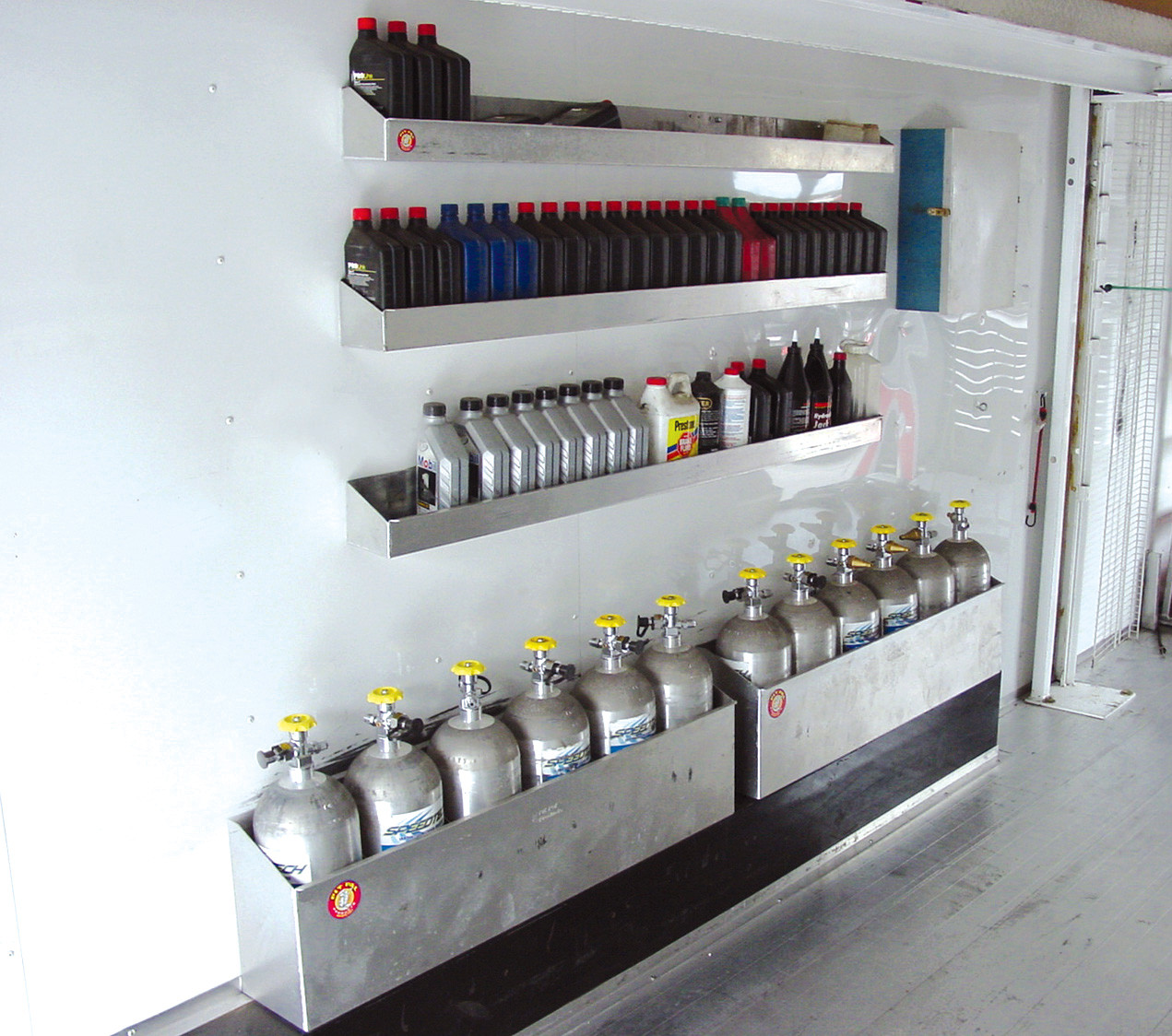 aluminum nitrous bottle holder mounted to trailer wall