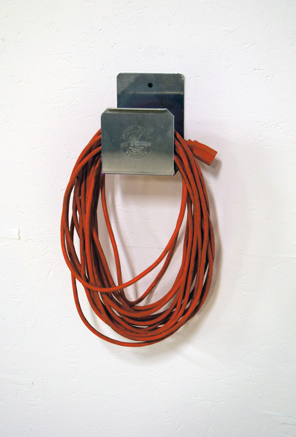extension cord hanger mounted to wall