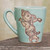 Light Blue Celadon Ceramic Dancing Ganesha Mug from Thailand 'Whimsical Ganesha' Light Blue Celadon Ceramic Dancing Ganesha Mug from Thailand 'Whimsical Ganesha'