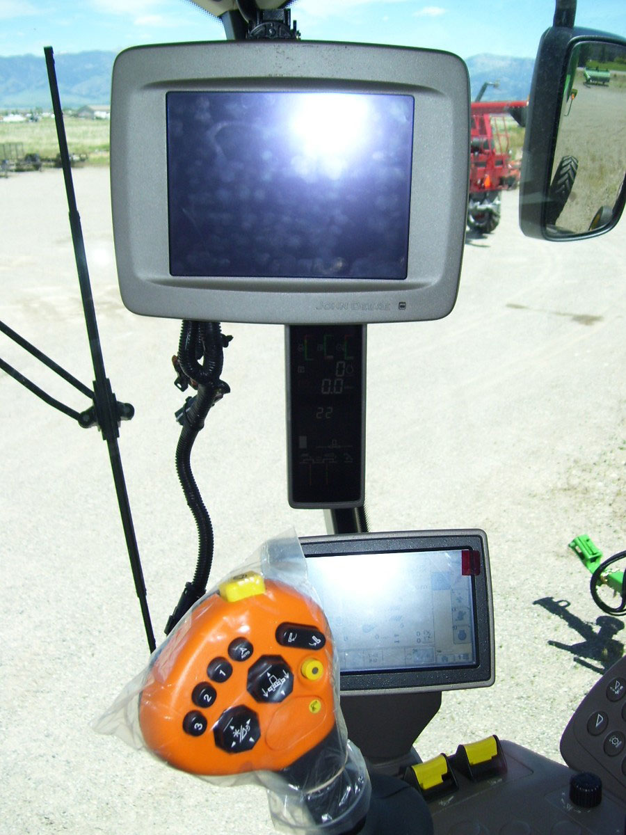 John Deere 2600 display installed on under radio bracket in John Deere S-Series Combine Cab bracket