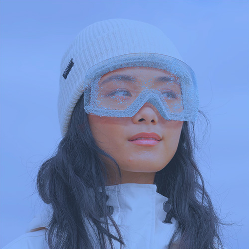 woman wearing a winter hat and ski goggles