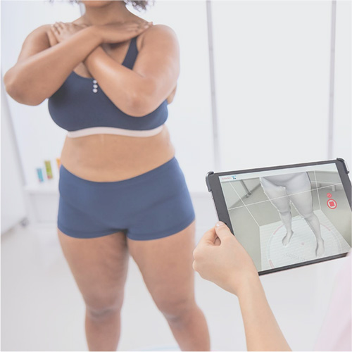 woman being scanned on an iPad with attached Structure Sensor 3