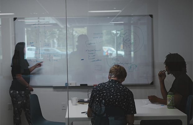 team around a table with computers