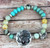 Burnished Silvertone 'Farm Sweet Farm' Turquoise Beaded Stretch Bracelet with Rooster and Cow Pendant Burnished Silvertone 'Farm Sweet Farm' Turquoise Beaded Stretch Bracelet with Rooster and Cow Pendant