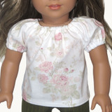 Fits 18" dolls
Includes: top
Woven top with elasticized neck and cuffs. Short sleeves. Velcro closure in back.
Fabric: 100% cotton.
Color: white, pink, dusty green