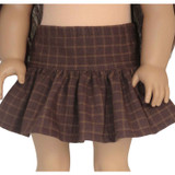 Fits 18" dolls like AG and OG
Includes: skirt
Mini skirt with ruffle. Elastic waist.
Fabric: 100% cotton
Color: brown, camel

Channel cozy library vibes with this classic plaid skirt in rich brown and camel. The ruffle bottom adds a playful touch to any light academia outfit.