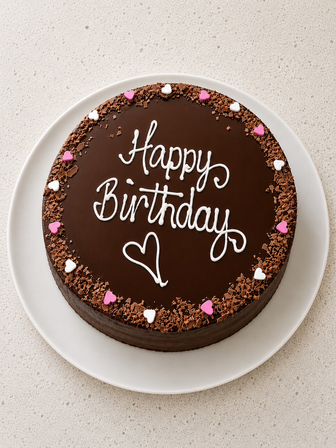 Chocolate birthday cake Auckland with Happy Birthday writing and heart decorations