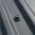 RoofingPro RS70 Roofing Screws - 70mm - RAL 7016 Anthracite Grey with a grey powder coated screw head used to stop water ingress into a corrugated steel roof.