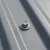 RoofingPro RS70 Roofing Screws - 70mm - RAL 7042 Traffic Grey with a medium grey powder coated screw head used in a corrugated steel roof