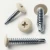 Various angles of the RAL 1013 oyster white painted wafer head screws with self drilling points for use with metalwork.