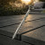 DeckingPro DS65 RAL 7009 Green Grey colour matched composite decking screw shown on dark composite decking boards outdoor