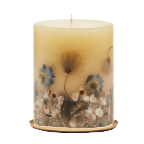 5 inch pillar candle sitting on round gold plate