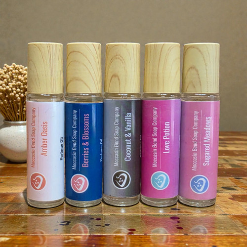 A collection of 5, 10ml roller bottles of perfume oil from moccasin bend soap company.
