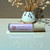 A single, 10 ml roller bottle of perfume oil from moccasin bend soap company in the scent Amber Oasis.