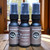 A collection of multiple, half oz, black ,spray bottle of body cologne from moccasin bend beard in the scent Blackened Vanilla.