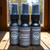 A collection of multiple, half oz, black ,spray bottle of body cologne from moccasin bend beard in the scent Kentucky Bourbon.