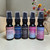 A collection of five, half oz, black ,spray bottle of body perfume from moccasin bend soap.