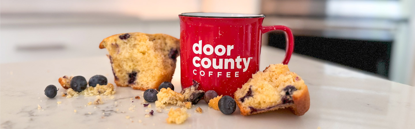 Door County Coffee mug next to some desserts