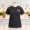 The front of Door County Coffee Original Grey Tshirt in a white kitchen