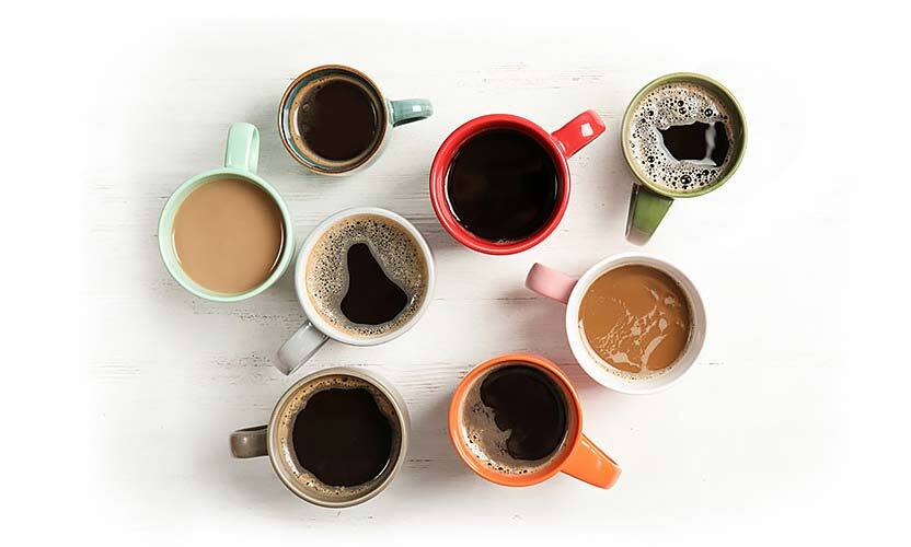 overhead view of colorful coffee mugs with varying brew strengths