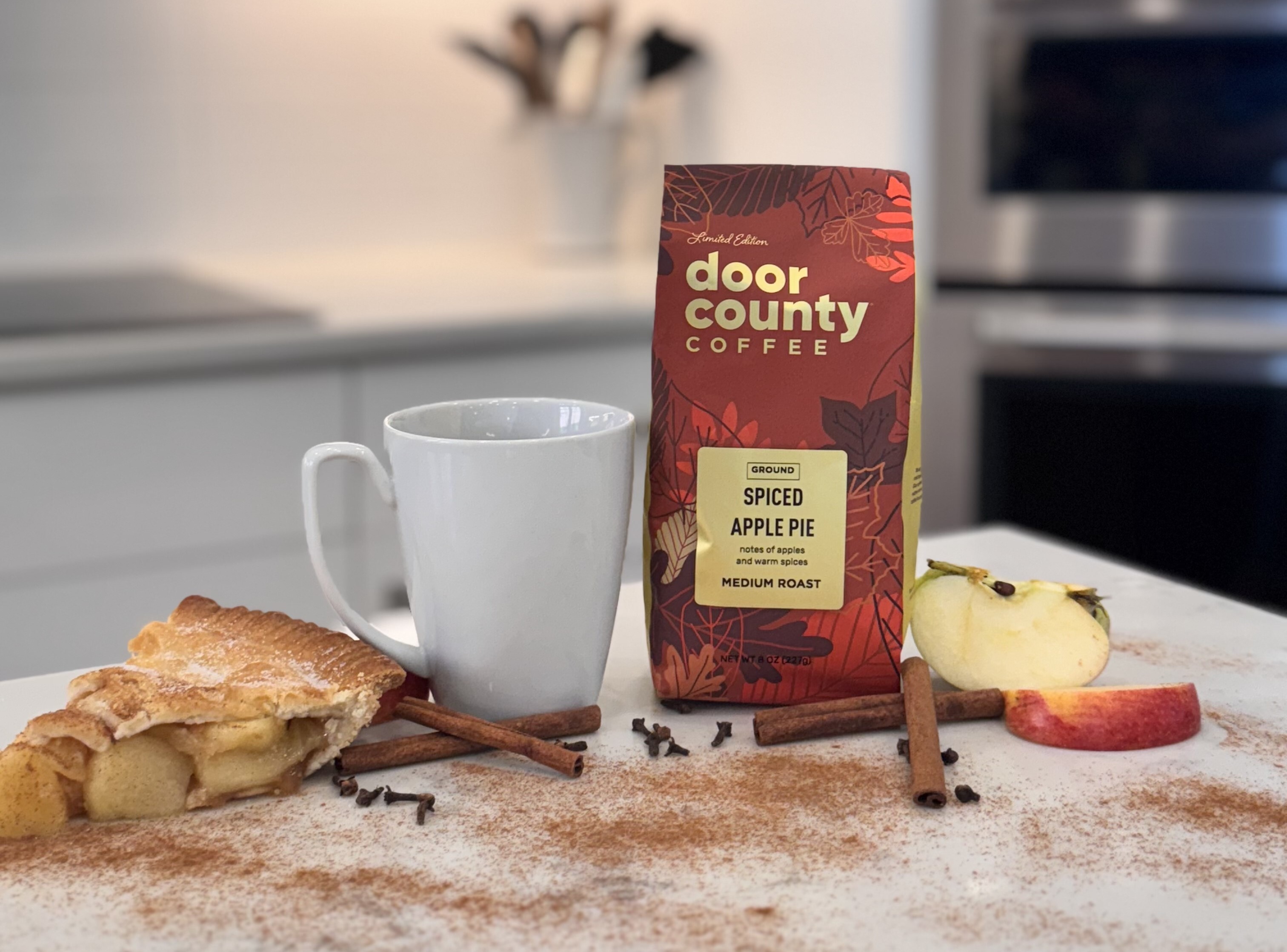 A BAG OF SPICED APPLE PIE COFFEE AND PEICE OF APPLE PIE
