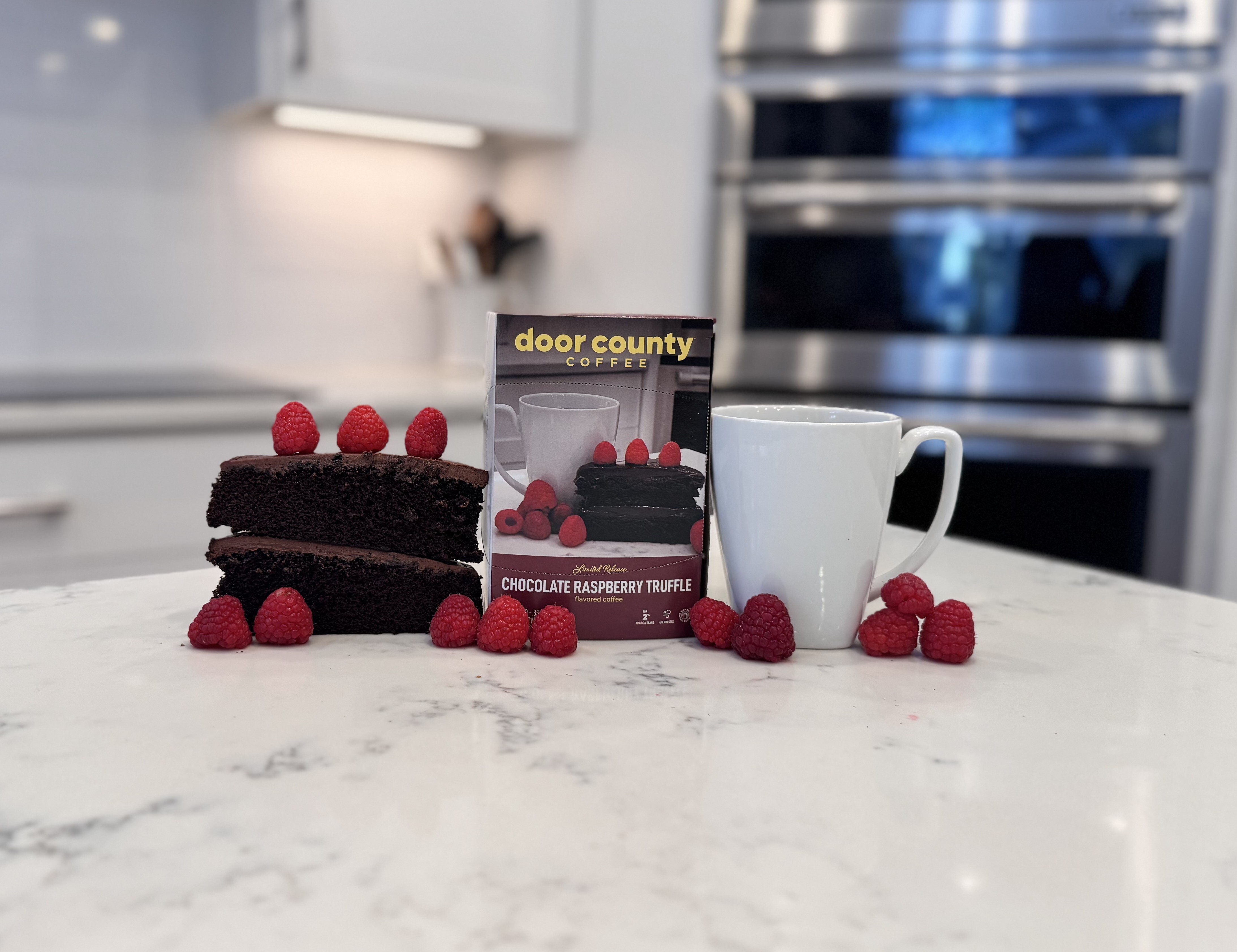 A bag of coffee with blueberries , raspberrie sand white chocolate on the counter