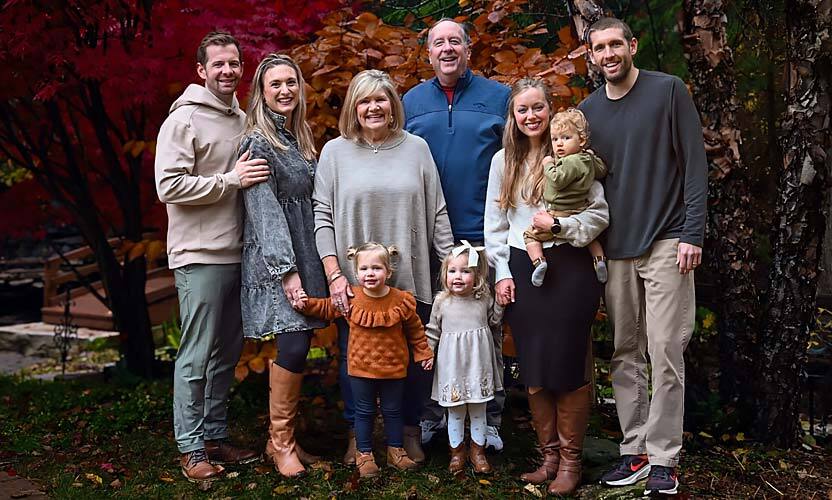 The Wilson family in front of pine trees