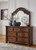 Lavinton - 7 Pc. - Dresser, Mirror, California King Poster Bed, 2 Nightstands - Brown