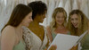 Bride and friends looking at a Wedding Video Book