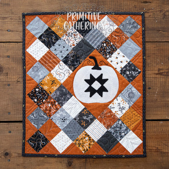 Here is a cute wall hanging for the entire fall season. Easy piecing with a mini charm for the background, and add your wool pumpkin embellishment.