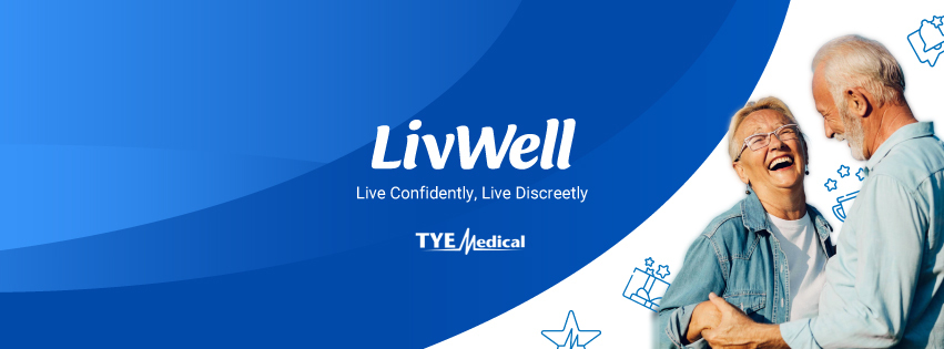 smiling senior couple in front of a banner reading "LivWell"
