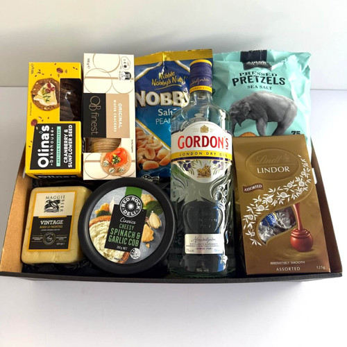 Indulgence Hamper with crackers, pretzels, Lindt chocolates, nuts, cheeses, and 700 ml spirits and more , wrapped in cellophane with ribbons