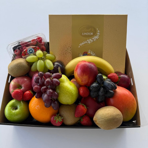 Sweet & Fresh Fruit Tray with seasonal fruit  and includes 235g of Lindt assorted chocolates, wrapped in cellophane with ribbons