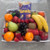 Sweet & Fresh Fruit Tray with seasonal fruit and 373 g box of favorite chocolates, wrapped in cellophane with ribbons