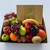 Sweet & Fresh Fruit Tray with seasonal fruit  and includes 235g of Lindt assorted chocolates, wrapped in cellophane with ribbons