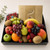 Sweet & Fresh Fruit Tray with seasonal fruit and includes 235g of Lindt assorted chocolates, wrapped in cellophane with ribbons, same-day delivery Naracoorte.