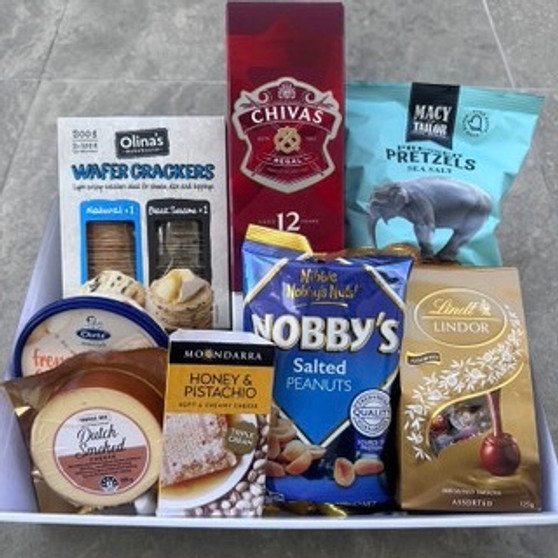 Gift hamper with pretzel, chocolates, nuts, dip, cheese, crackers and bottle of spirits.