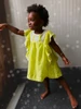 Toddler girl wearing lemon yellow angel-sleeve dress with white crochet lace trim - Sophie Catalou Kate Dress