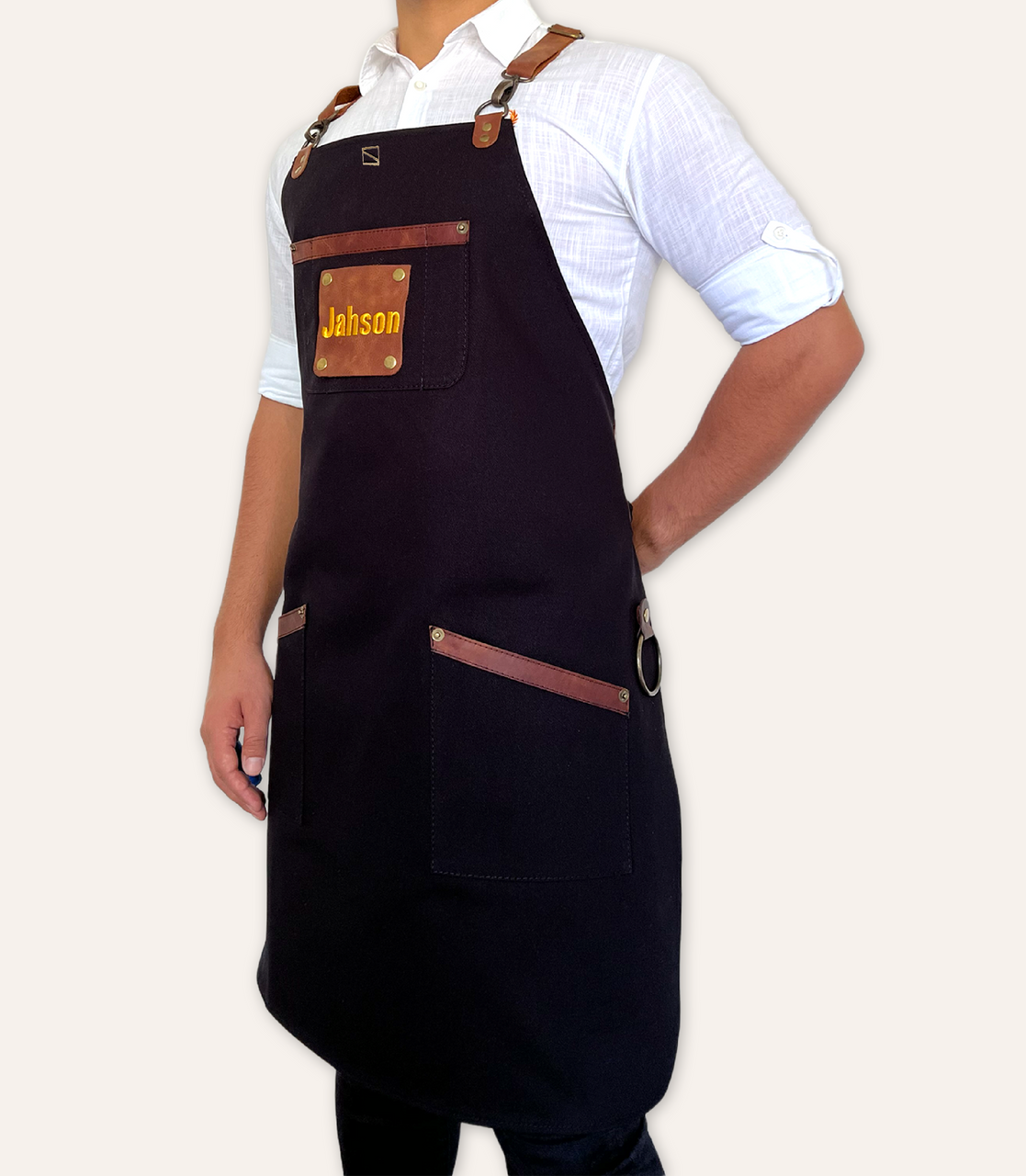 https://cdn11.bigcommerce.com/s-4lp3aqlzu7/images/stencil/1280x1280/products/257/1196/Durable_Black_Canvas_water_proof_Apron_with_Cross-Back_Leather_Straps__78316.1693968185.png?c=1