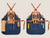 Navy waxed canvas apron with brown leather straps for chefs, baristas and creative professionals