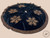 Handmade 55-inch black velvet Christmas tree skirt with elegant rhinestone snowflakes, metallic crystal embellishments and a circular design with tie closures.